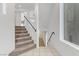 Modern staircase with carpet and window, designed for an open and airy feel at 7075 Jasper Hill Way, Las Vegas, NV 89118