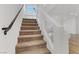 Carpeted staircase with a metal railing and window overlooking the backyard at 7075 Jasper Hill Way, Las Vegas, NV 89118