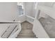 Carpeted stairs with glass railings lead to a well-lit upper level at 7075 Jasper Hill Way, Las Vegas, NV 89118
