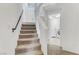 Carpeted stairs lead to the upper level, with natural light and a modern aesthetic at 7075 Jasper Hill Way, Las Vegas, NV 89118