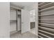Bright walk-in closet features custom shelving and ample storage space, perfect for organizing any wardrobe at 7075 Jasper Hill Way, Las Vegas, NV 89118