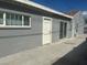 Rear view of a house showing a white door and sliding glass door at 721 N 1St St, Las Vegas, NV 89101