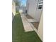 Landscaped side yard with artificial turf and walkway at 721 N 1St St, Las Vegas, NV 89101