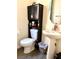 Small bathroom with pedestal sink and dark wood cabinet at 7529 Earnshaw Ave, Las Vegas, NV 89149