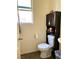 Small bathroom with toilet and dark wood storage cabinet at 7529 Earnshaw Ave, Las Vegas, NV 89149