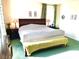 King-size bed in a spacious main bedroom with green carpet at 7529 Earnshaw Ave, Las Vegas, NV 89149