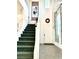 Two-story entryway with green carpeted staircase and decorative wreath at 7529 Earnshaw Ave, Las Vegas, NV 89149