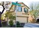 Two-story house with beige exterior, two-car garage, and landscaping at 7529 Earnshaw Ave, Las Vegas, NV 89149