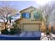 Two-story house with a beige exterior, two-car garage, and landscaping at 7529 Earnshaw Ave, Las Vegas, NV 89149