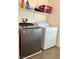 Functional laundry room with washer, dryer, and shelving at 7529 Earnshaw Ave, Las Vegas, NV 89149