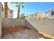 Small, enclosed backyard with block wall and dirt at 7741 Orchard Wood Ct, Las Vegas, NV 89131