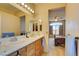 Double vanity bathroom with a view of bedroom at 7741 Orchard Wood Ct, Las Vegas, NV 89131