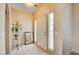 Inviting entryway with tiled flooring, mirror, and plant stand at 7741 Orchard Wood Ct, Las Vegas, NV 89131