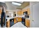 Modern kitchen with stainless steel appliances and light wood cabinets at 7741 Orchard Wood Ct, Las Vegas, NV 89131