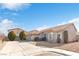 Single-story home with a tile roof, driveway, and landscaping at 7859 Lisa Marie Ct, Las Vegas, NV 89113