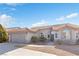 Front view of a single-story house with a garage and landscaping at 7859 Lisa Marie Ct, Las Vegas, NV 89113