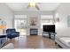 Bright living room with fireplace, hardwood floors, and sliding glass doors to backyard at 7859 Lisa Marie Ct, Las Vegas, NV 89113