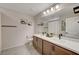 Bathroom with double vanity, large mirror, and shower/tub combo at 8035 Skye Foxx St, Las Vegas, NV 89166