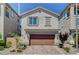 Two-story house with brown garage door and landscaped yard at 8035 Skye Foxx St, Las Vegas, NV 89166