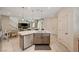 Kitchen island with seating and a view into the living room at 8035 Skye Foxx St, Las Vegas, NV 89166