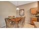 Bright dining area with wood table and chairs, adjacent to kitchen at 8805 Jeffreys St # 1032, Las Vegas, NV 89123