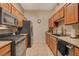 View of kitchen with stainless steel appliances and wood cabinets at 8805 Jeffreys St # 1032, Las Vegas, NV 89123