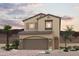 Two-story house with brown garage door and landscaping at 889 Pointe Arbor St, Henderson, NV 89011