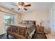 Bedroom with wooden sleigh bed, nightstand and balcony access at 9103 Mcginnis Ave, Las Vegas, NV 89148