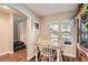 Bright dining area with a farmhouse table and wooden hutch at 9103 Mcginnis Ave, Las Vegas, NV 89148