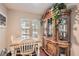 Country style dining area with wooden hutch and hardwood floors at 9103 Mcginnis Ave, Las Vegas, NV 89148