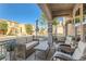 Relaxing front porch with wicker furniture and view of the street at 9103 Mcginnis Ave, Las Vegas, NV 89148