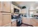 Kitchen with stainless steel appliances and light wood cabinets at 9103 Mcginnis Ave, Las Vegas, NV 89148