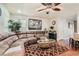 Living room with brown sectional sofa, hardwood floors and ceiling fan at 9103 Mcginnis Ave, Las Vegas, NV 89148