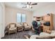 Home office with built-in desk and wicker chairs at 9103 Mcginnis Ave, Las Vegas, NV 89148