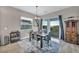 Bright dining room with a wooden table and access to a backyard patio at 928 Calluna Hills Ln, Las Vegas, NV 89138