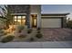 Modern home with stone and stucco exterior, two-car garage at 928 Calluna Hills Ln, Las Vegas, NV 89138