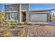 Modern home with stone accents and a two-car garage at 928 Calluna Hills Ln, Las Vegas, NV 89138