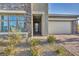 Front entry with stone accents and a glass front door at 928 Calluna Hills Ln, Las Vegas, NV 89138