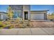 Modern home with stone facade and landscaped front yard at 928 Calluna Hills Ln, Las Vegas, NV 89138