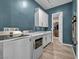 Bright laundry room with washer, dryer, and ample cabinetry at 928 Calluna Hills Ln, Las Vegas, NV 89138