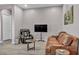 Relaxing living room with leather couches and a TV at 928 Calluna Hills Ln, Las Vegas, NV 89138