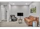 Relaxing living room with leather couches and a TV at 928 Calluna Hills Ln, Las Vegas, NV 89138