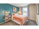 Charming bedroom with teal walls, metal bed frame, and patterned curtains at 9392 Serene Harbor St # Lot 24, Las Vegas, NV 89178