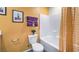 Clean bathroom with yellow walls, tub, and shower at 9436 Peaceful River Ave # Lot 63, Las Vegas, NV 89178