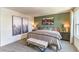 Spacious bedroom with a king-size bed and a green accent wall at 9436 Peaceful River Ave # Lot 63, Las Vegas, NV 89178