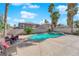 Palm trees surround the inground pool and outdoor seating area, perfect for enjoying sunny days in the backyard at 9852 Snowy Canyon Ct, Las Vegas, NV 89183