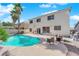 Relax poolside in this backyard oasis, complemented by palm trees and an outdoor seating area at 9852 Snowy Canyon Ct, Las Vegas, NV 89183