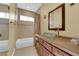 Bathroom featuring a glass door shower, unique sink, and ample cabinet space at 9852 Snowy Canyon Ct, Las Vegas, NV 89183