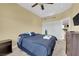 Bedroom featuring a vaulted ceiling, with a ceiling fan and a large bed with blue comforter at 9852 Snowy Canyon Ct, Las Vegas, NV 89183