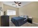 Spacious bedroom with a queen bed, ceiling fan, and ample closet space at 9852 Snowy Canyon Ct, Las Vegas, NV 89183